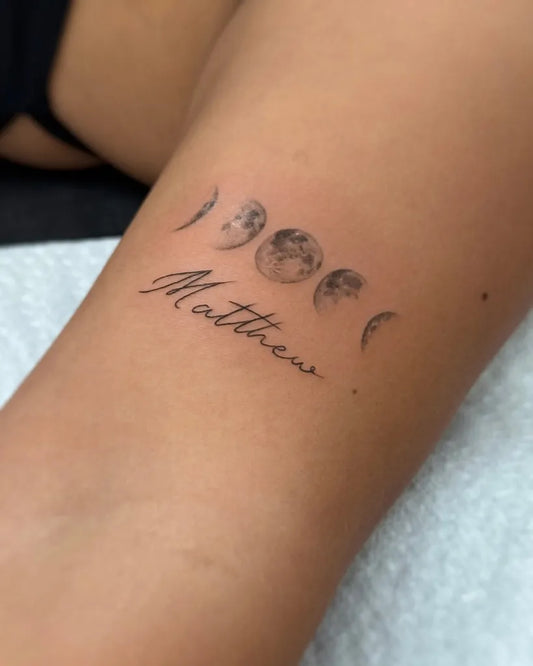 Small Fine Line Moon Phases and Name Tattoo on Women Arm by @tattoosbycarol