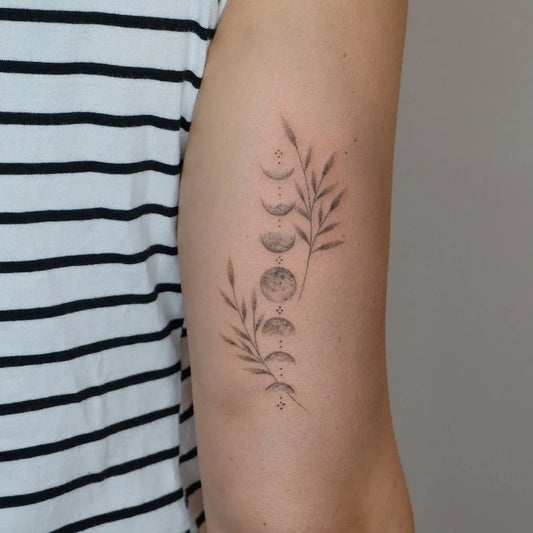 Small Fine Line Moon Phases and Olive Branch Tattoo on Women Arm by @sonia.pinkdust