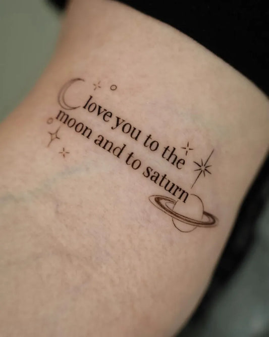 Small Fine Line Moon Saturn Love Quote Tattoo on Women Arm by @theblondietattoos