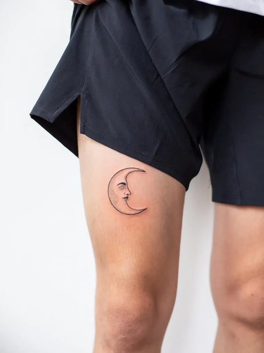 Small Fine Line Moon Tattoo on Women Thigh by @annedekkertattoo