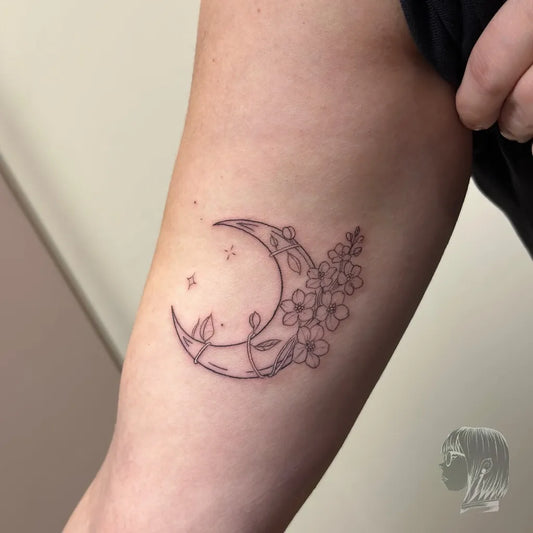 Small Fine Line Moon and Flowers Tattoo on Women Arm by @aldyne.ink