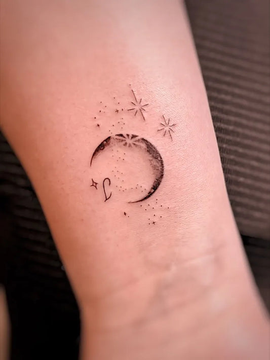 Small Fine Line Moon and Stars Tattoo on Women Arm by @juanita.tattoo_