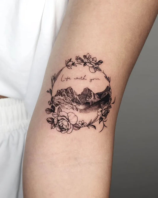 Small Fine Line Mountain Flowers Tattoo on Women Arm by @ejintatt