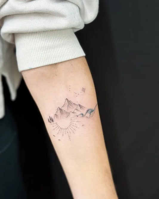 Small Fine Line Mountain Sun Waves Tattoo on Women Forearm by @restlessmouse.art