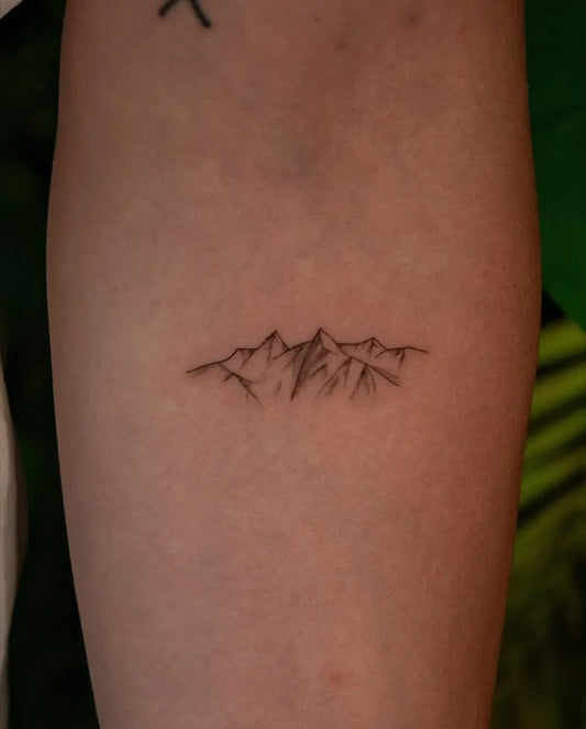 Small Fine Line Mountain Tattoo on Women Forearm by @pauline.tattoo