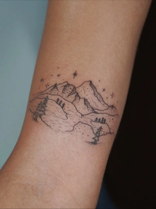 Small Fine Line Mountain Trees Stars Nature Tattoo on Women Arm by @poeticpokes