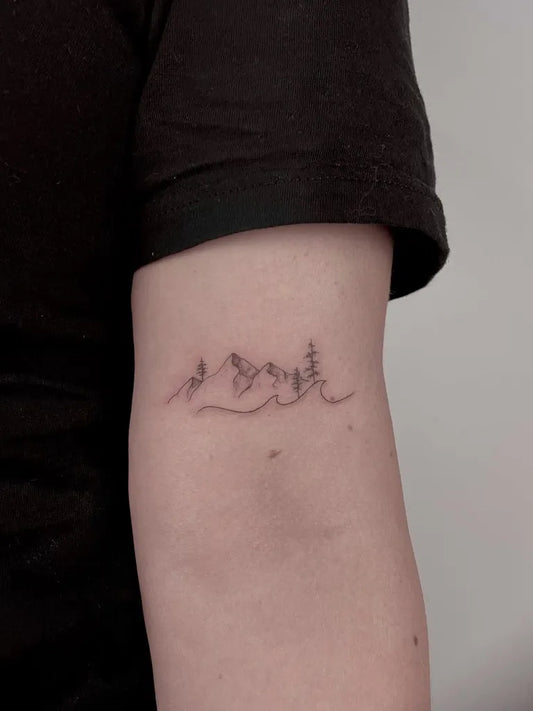 Small Fine Line Mountain and Tree Tattoo on Women Arm by @daria.inkwaves