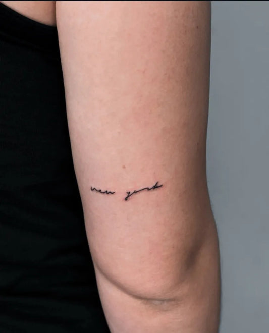 Small Fine Line New York Quote Tattoo on Women Arm by @flowline_ink