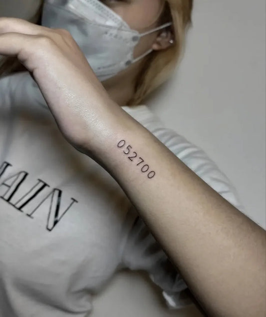 Small Fine Line Numbers Tattoo on Women Wrist by @omustattoo