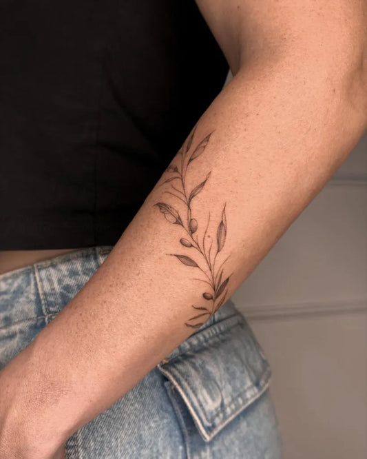 Small Fine Line Olive Branch on Women Forearm Tattoo by @geo.tattoos