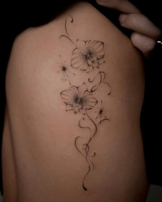 Small Fine Line Orchid Flowers Tattoo on Women Back by @joujou.tatt