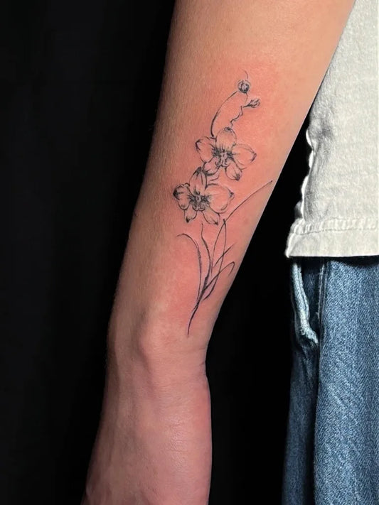Small Fine Line Orchid Tattoo on Women Arm by @leekaren.tatt