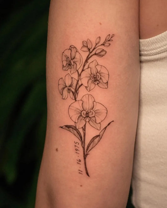 Small Fine Line Orchid Tattoo on Women Arm by @pauline.tattoo