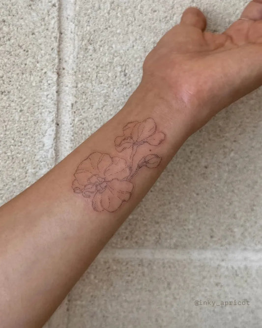Small Fine Line Orchid Tattoo on Women Wrist by @inky_apricot