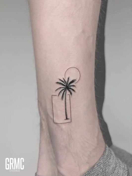 Small Fine Line Palm Tree Sun Frame Tattoo on Men Ankle by @grmcstudios
