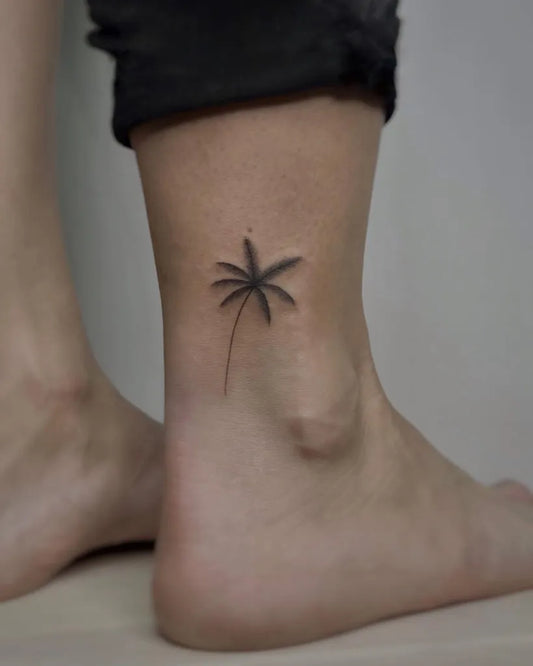 Small Fine Line Palm Tree Tattoo on Women Ankle by @alyonagarasayan_tattoo