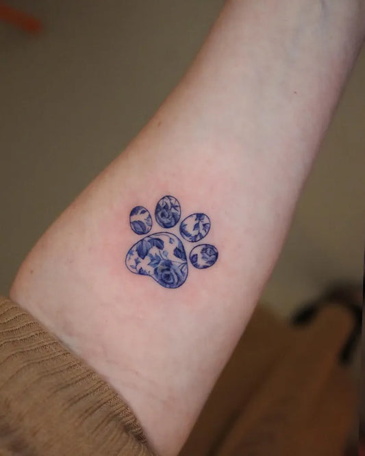 Small Fine Line Paw Print Tattoo on Women Forearm by @wontattoos