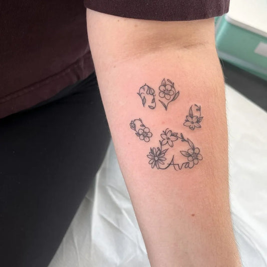 Small Fine Line Paw Print with Flowers Tattoo on Women Forearm by @beckz_m