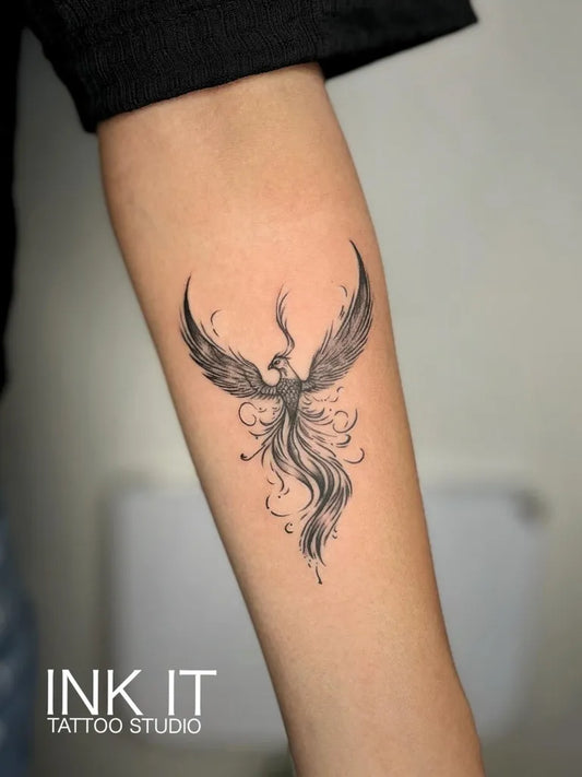Small Fine Line Phoenix on Women Arm Tattoo by @inkit_tattoostudio