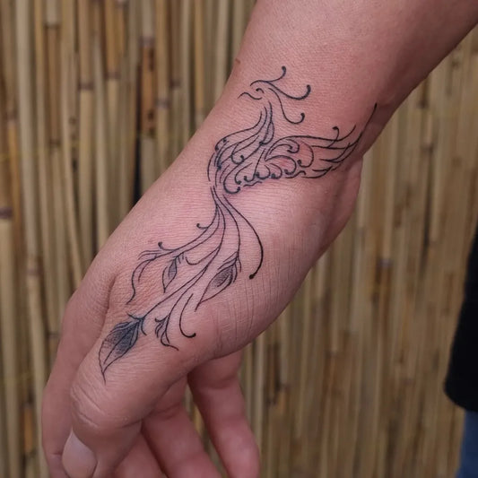 Small Fine Line Phoenix on Women Wrist Tattoo by @nurselyesilcam_tattooer