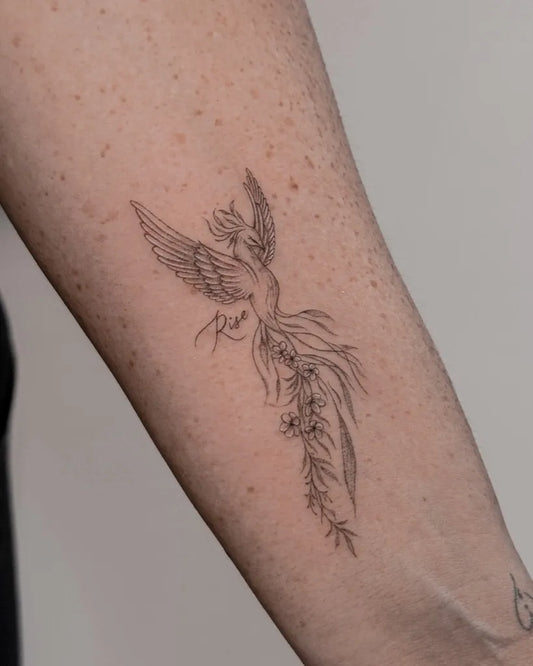 Small Fine Line Phoenix with Flowers on Women Arm Tattoo by @who_is_agne