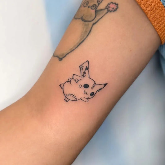 Small Fine Line Pikachu Tattoo on Women Arm by @lynnnova.ink