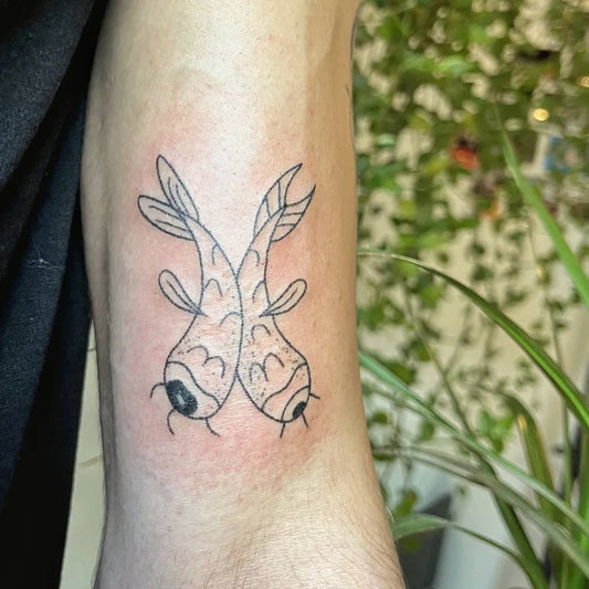 Small Fine Line Pisces Tattoo on Women Arm by @okadosa.tattoo