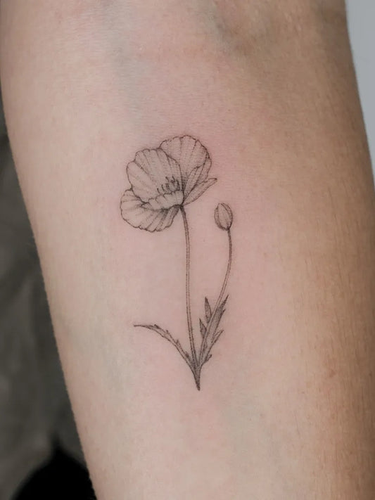 Small Fine Line Poppy Flower Tattoo on Women Arm by @emma.tattoos