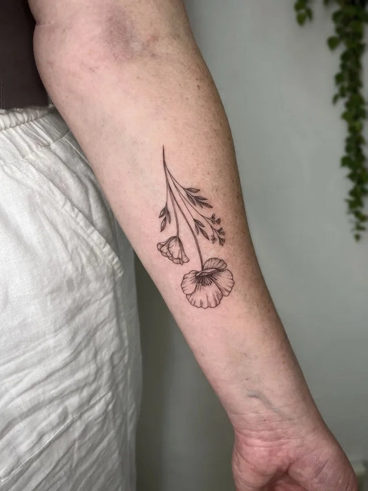 Small Fine Line Poppy Flowers Tattoo on Women Arm by @carleygracetattoos