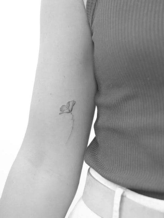 Small Fine Line Poppy Tattoo on Women Arm by @natalie.vadelma