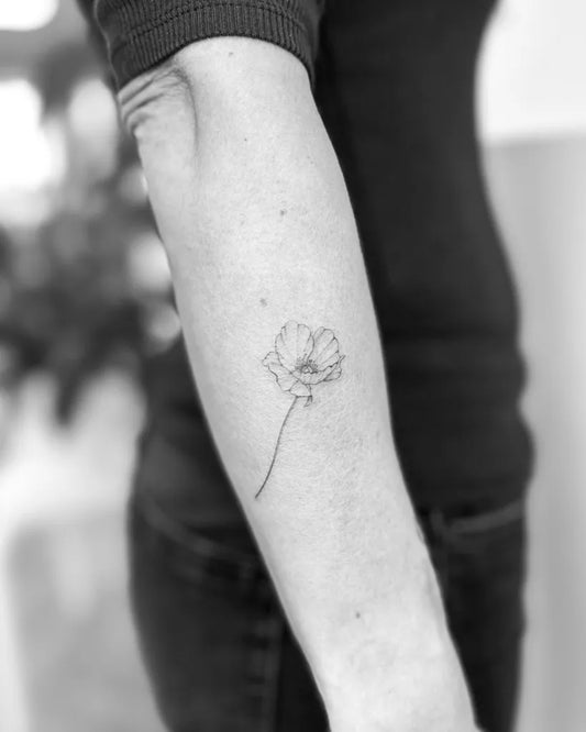 Small Fine Line Poppy Tattoo on Women Arm by @purelinestattoo