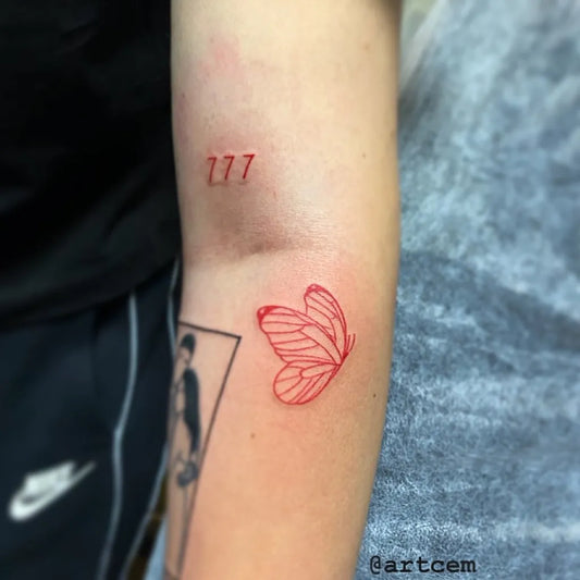 Small Fine Line Red 777 Butterfly Tattoo on Women Arm by @riptattoo666