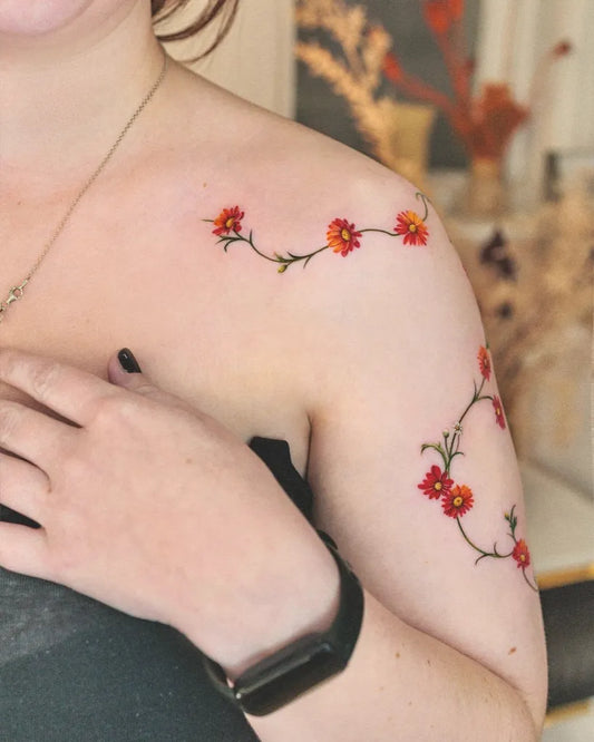 Small Fine Line Red Daisy Chain Vine Tattoo on Women Shoulder by @ssuncolor
