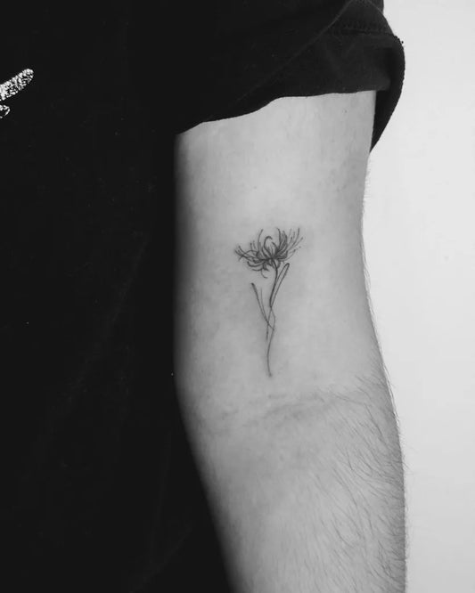Small Fine Line Red Spider Lily Tattoo on Men Arm by @letis.tattoo