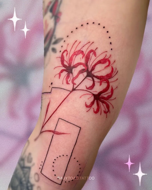Small Fine Line Red Spider Lily Tattoo on Women Arm by @babytoad.tattoo