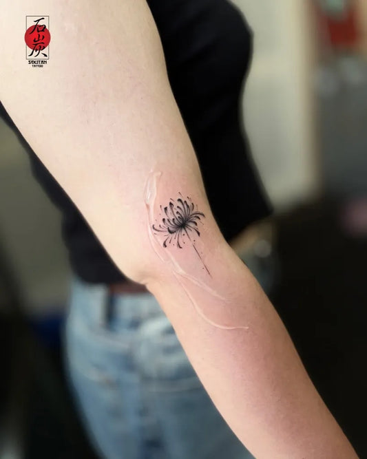 Small Fine Line Red Spider Lily Tattoo on Women Arm by @sekitantattoo