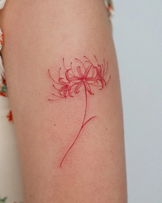 Small Fine Line Red Spider Lily Tattoo on Women Arm by @suya.rchive