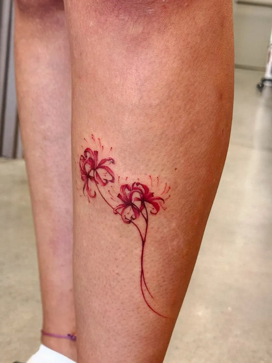 Small Fine Line Red Spider Lily Tattoo on Women Leg by @j.tattoo.1010