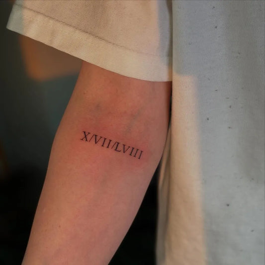 Small Fine Line Roman Numerals Tattoo on Women Forearm by @butterfly_._tattoo