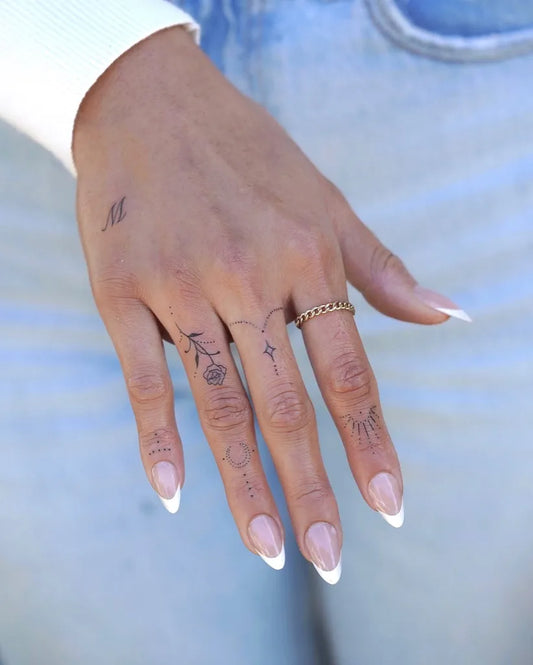 Small Fine Line Rose Cross Bird on Women Fingers Tattoo by @bella.tinytatts