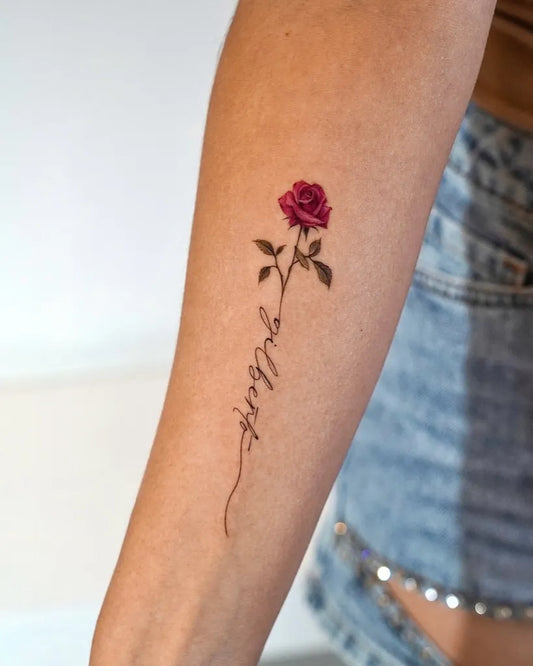 Small Fine Line Rose and Script on Women Arm Tattoo by @o.ri_tattoo