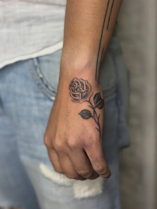 Small Fine Line Rose with Leaves on Men Wrist Tattoo by @thepoppymoon