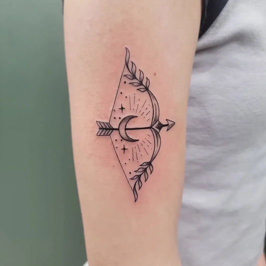 Small Fine Line Sagittarius Bow and Moon Tattoo on Women Forearm by @aestheticcraze