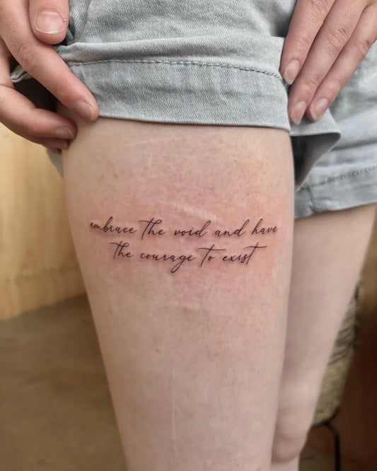 Small Fine Line Script Quote Tattoo on Women Thigh by @inkypalette.tattoos