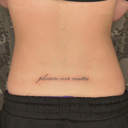 Small Fine Line Script Tattoo on Women Lower Back by @marsdentat