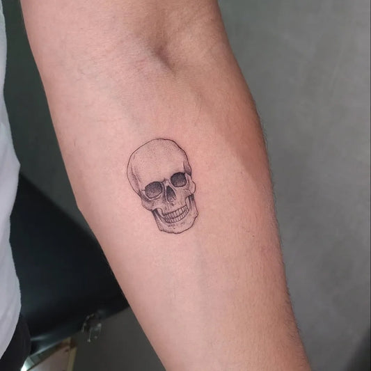 Small Fine Line Skull on Men Arm Tattoo by @alexherndzstudio