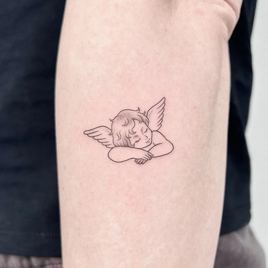 Small Fine Line Sleeping Angel on Women Arm Tattoo by @zoeylinink