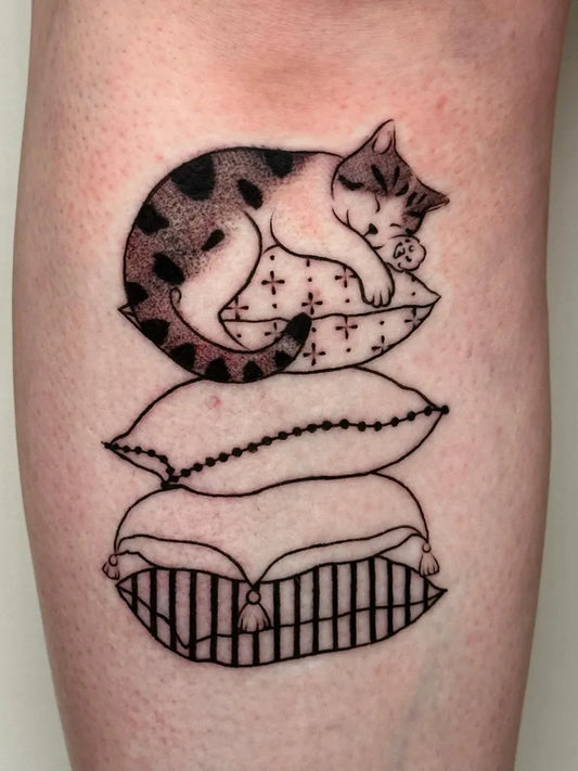Small Fine Line Sleeping Cat on Pillows Tattoo on Women Arm by @bloodxbonds