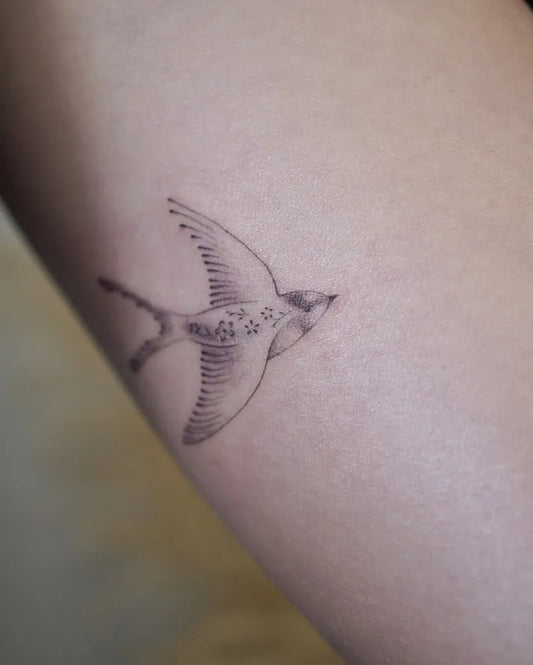 Small Fine Line Sparrow Tattoo on Women Arm by @mari__tattoos