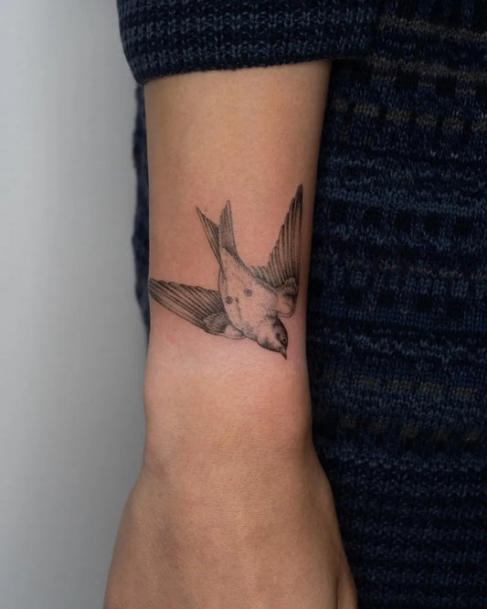 Small Fine Line Sparrow Tattoo on Women Wrist by @emma.tattoos